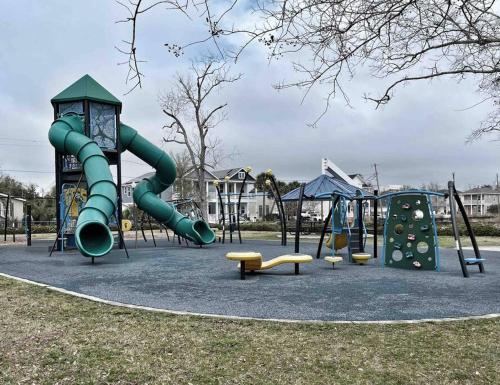 a playground with a slide and other playground equipment at Cheerful 3BR close to downtown + double balcony in Pensacola