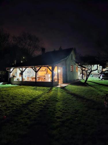 a house lit up at night in a field at Fruška house in Bešenovački Prnjavor