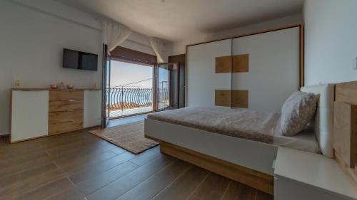 a bedroom with a bed and a view of the ocean at Enchanted Bay House in Kefallonia