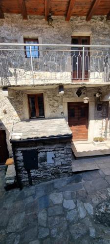 a stone building with a balcony on top of it at Ca Angela in Mergozzo