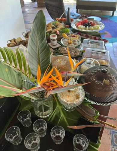 a table with a bunch of food on it at Hotel Casa Paradiso Guarujá in Guarujá