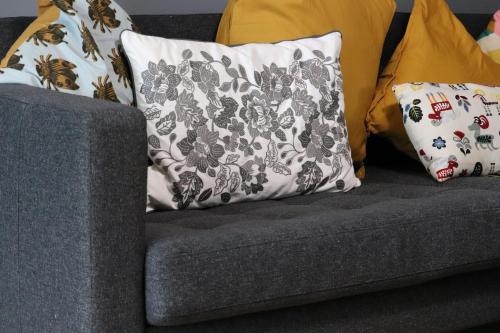 a gray couch with pillows on it at Hughes contemporary home in Barnstaple by StayStay com in Barnstaple