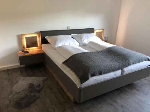 uma cama grande num quarto com duas mesas de cabeceira em Ferienhaus Bibernest em Münsingen