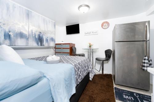 ein kleines Schlafzimmer mit einem Bett und einem Kühlschrank in der Unterkunft Exquisite in Brooklyn