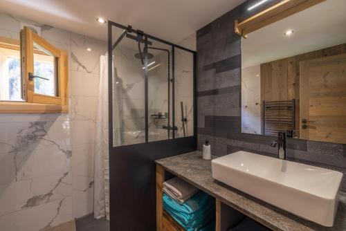 a bathroom with a sink and a shower at Chalet Quartz in Saint-Gervais-les-Bains