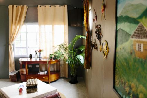 a living room with a table and a window at Galina Breeze in Port Maria