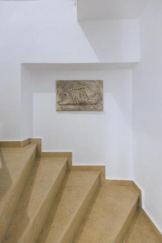 a painting on a wall next to some stairs at Filocsenia luxury apartment at tsoutsouras in Tsoútsouros