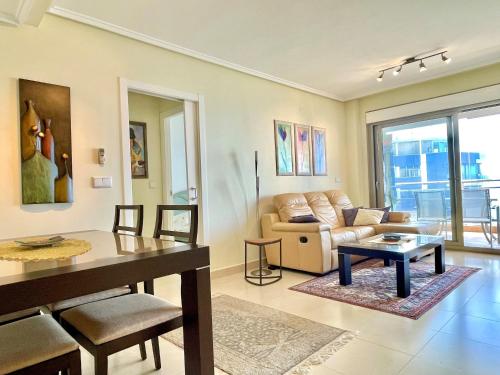 a living room with a couch and a table at Bahía del Sol 17C Peñon & Sea View Arenal Beach in Calpe