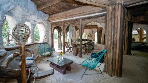 a living room with chairs and a table in a house at Portal Xibalba in Playa del Carmen