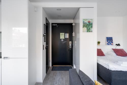 a bedroom with a bed and a couch in a room at Hiisi Homes Helsinki Haaga in Helsinki