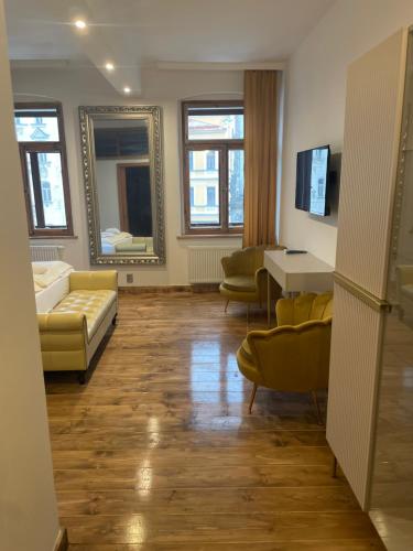 a living room with a couch and a table at Pension & Restaurant Atmosféra in Loket