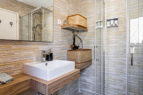 W łazience znajduje się umywalka i przeszklony prysznic. w obiekcie Casa Paraíso Cascais w mieście Cascais