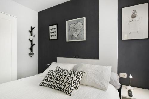 a bedroom with a black accent wall and a bed at yojalavi sunrise in Candelaria