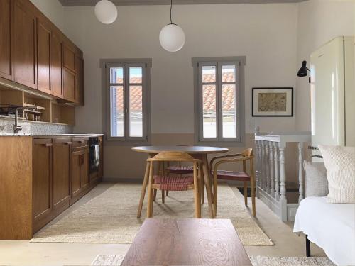 a kitchen with a table and chairs in a room at Giasemi house with sea view in Panormos Skopelos
