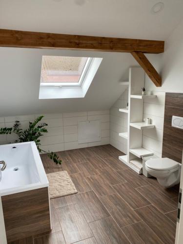 a bathroom with a white sink and a toilet at Lieblingsplatz an der Lahn in Weinbach