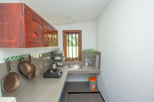a kitchen with a sink and a counter top at Greenway Apartment in Galle