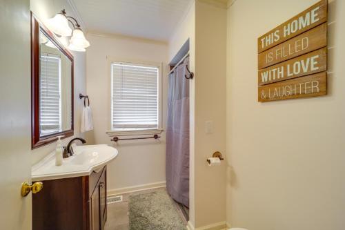 a bathroom with a sink and a shower and a mirror at Cozy Damascus Cottage with Porch and Trail Access! in Damascus