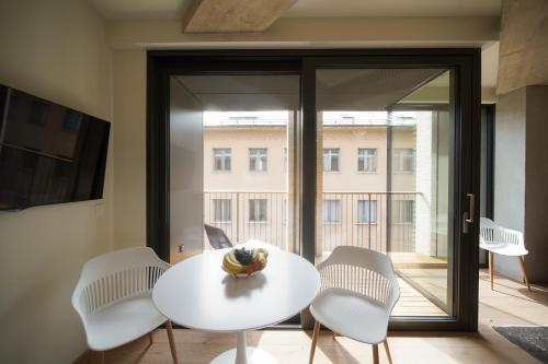 a white table and chairs in a room with a window at Castle View Luxury Suite in Ljubljana