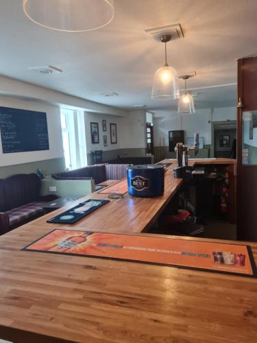 a kitchen with a wooden counter top in a room at Victoria Hotel in Portknockie
