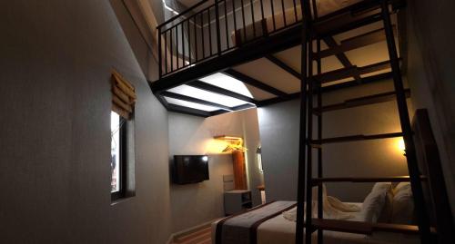 a bedroom with two bunk beds and a ladder at 1969 Business Suites @ Ipoh Garden in Ipoh