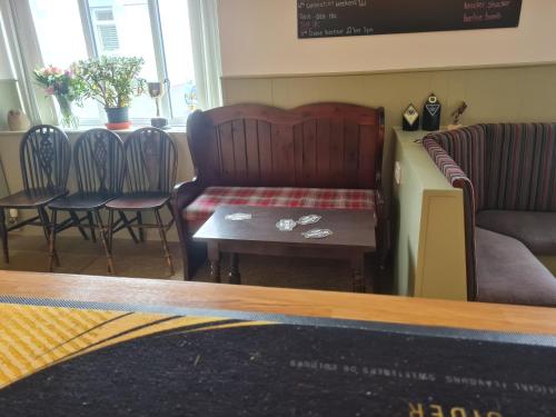 a living room with a couch and a table and chairs at Victoria Hotel in Portknockie