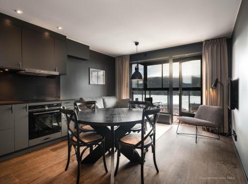 a kitchen and dining room with a table and chairs at Stunning Apartment in View Are Ski in - Vm8 Lift in Åre