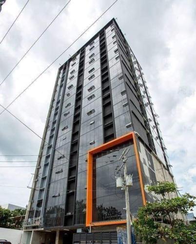 a tall glass building with a large window at BLOQ RESIDENCES 12th floor in Cebu City