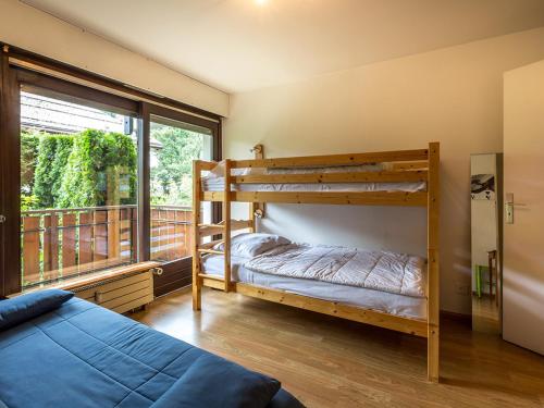 a bedroom with two bunk beds and a balcony at Appartement La Clusaz, 3 pièces, 8 personnes - FR-1-437-36 in La Clusaz