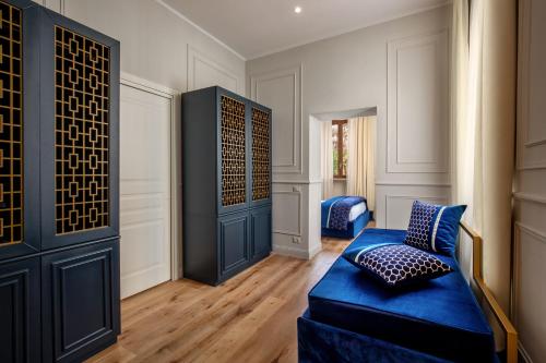 a living room with a blue couch and a wall at Navona Sky Palace in Rome