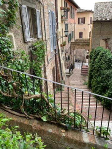 an alley with a railing next to a building at Casa Tre Gradini in Perugia
