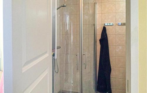 a shower with a glass door with a towel on it at 2 Bedroom Stunning Home In Norrtlje in Norrtälje