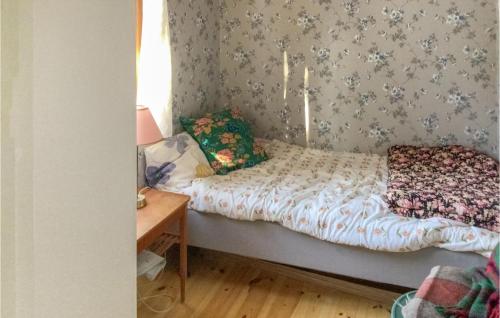 a small bedroom with a bed and a table at 2 Bedroom Stunning Home In Norrtlje in Norrtälje