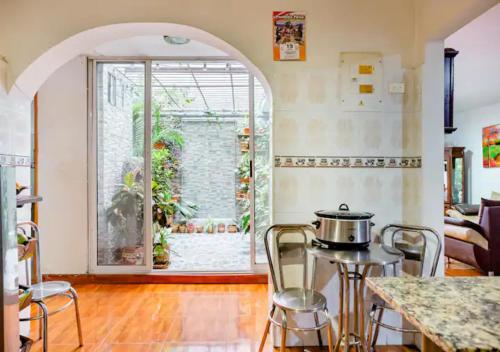 a kitchen with an archway and a table with a pot on it at Nora's HomeStay Laureles in Medellín