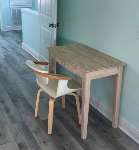 a wooden table with a chair and a wooden desk at Downtown home + bay views + seafood market in Pensacola