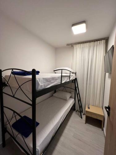 a room with two bunk beds and a television at CARA Creta Home in Kolymvari