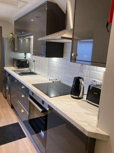 a kitchen with a sink and a counter top at Stunning Coastal Retreat in Carrickfergus