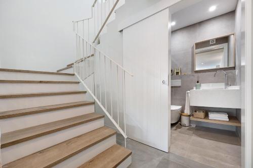 - un escalier dans la salle de bains pourvue d'un lavabo et de toilettes dans l'établissement Casa Helena, à Ferragudo