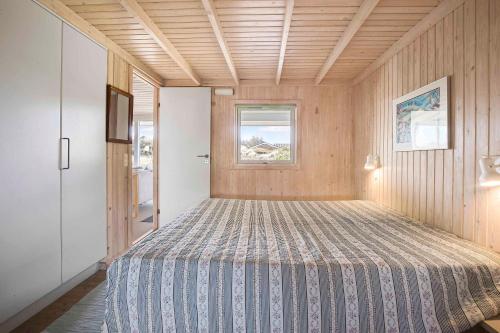 a bedroom with a large bed in a room at Summer House With Sea View In The Dunes in Pandrup