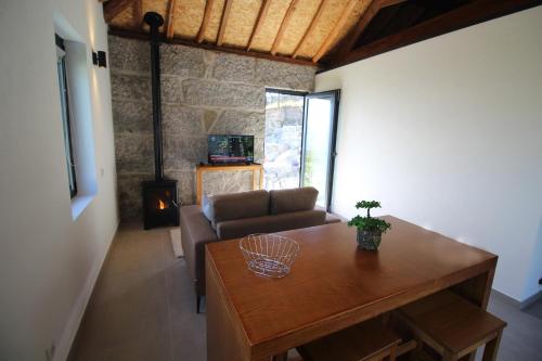 a living room with a couch and a table at Casas do Campo da Moita in Baião