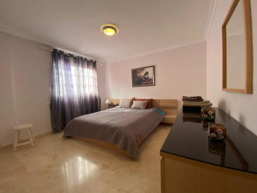 a bedroom with a bed and a table in a room at Superior Apartment with Ocean View in Callao Salvaje