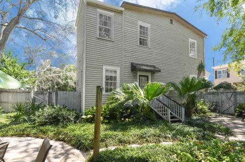 a house with a fence in front of it at Charming Savannah Duplex Courtyard Parking in Savannah