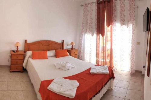 a bedroom with a bed with towels on it at Apartamento Jarmar Puerto Santiago in Puerto de Santiago