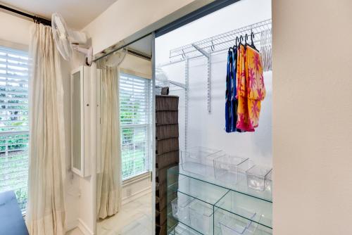 a bathroom with a glass walk in shower at New Smyrna Beach Cottage about 1 Mi to Downtown! in New Smyrna Beach