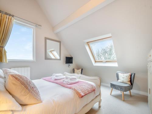 a bedroom with a bed and a window and a chair at Pears Cottage - Uk43674 in Beckington