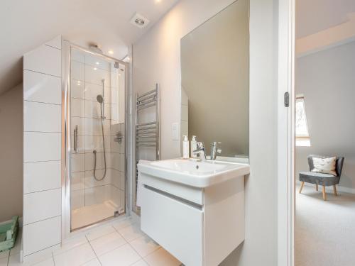 a white bathroom with a sink and a shower at Pears Cottage - Uk43674 in Beckington