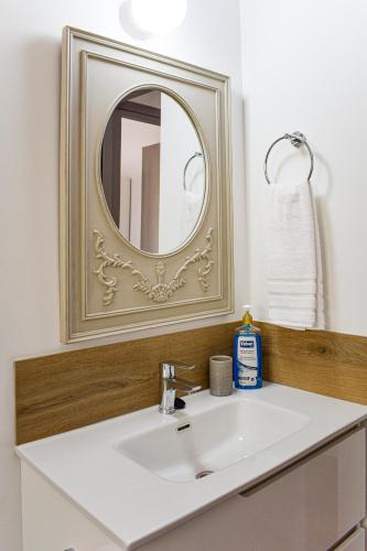 a bathroom with a sink and a mirror at Galatia's House in Kouklia