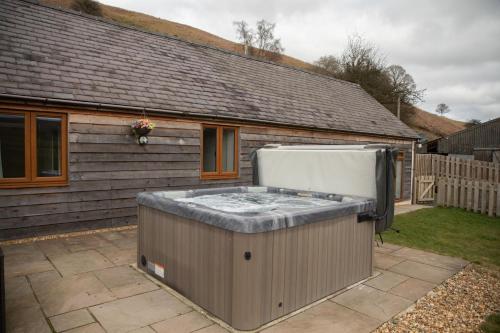 a hot tub in the backyard of a house at 1 Beacon View Barn in Felindre