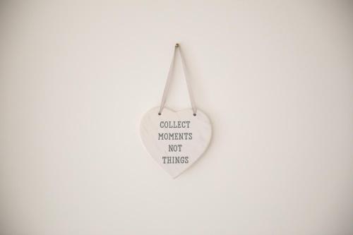 a white heart shaped sign that reads collect womens not things at 1 Beacon View Barn in Felindre