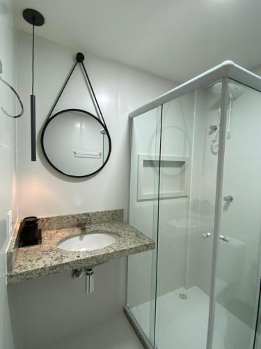 a bathroom with a sink and a mirror at Vilage Villa Andorinha - apt 09 in Mucugê