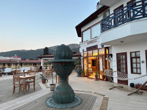 a large green vase sitting on a patio at NATURELLA APART HOTEL in Kemer